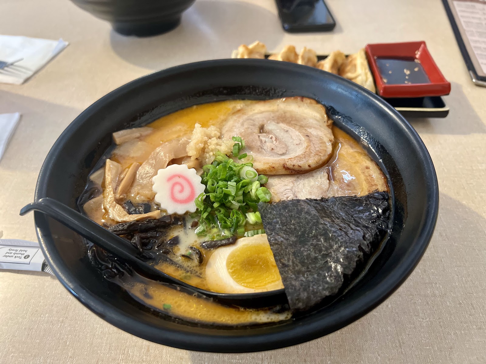 Fully loaded tonkotsu ramen bowl with chashu pork, egg, and nori