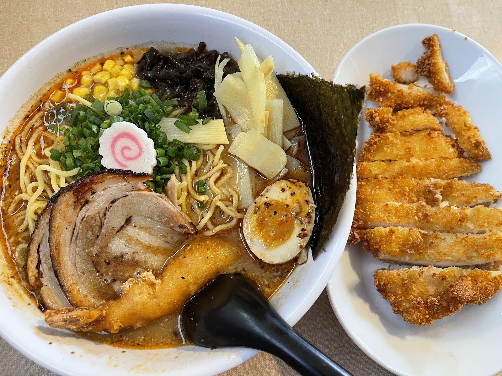 Ramen bowl with gyoza and crispy fried tonkatsu on the side